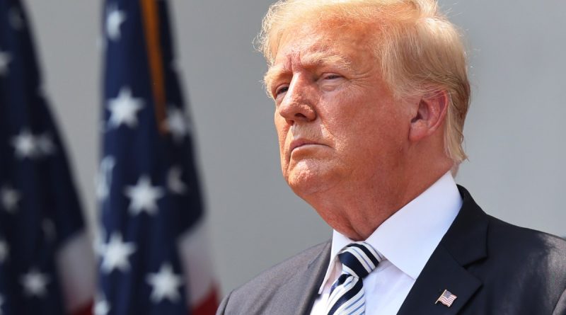 Trump in front of an American flag