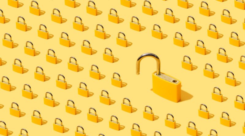 High-angle view of yellow padlocks on yellow background. One of them is open.