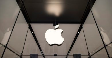 The Apple logo hangs above the entrance to the Apple Shinjuku store