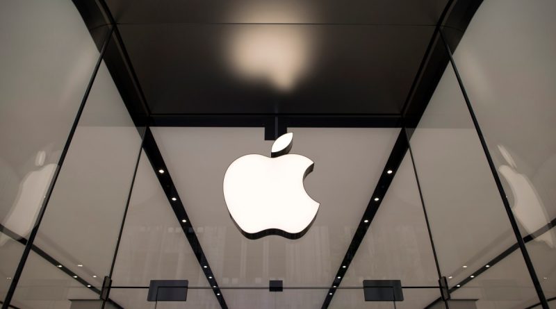 The Apple logo hangs above the entrance to the Apple Shinjuku store