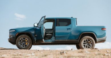 Blue Rivian R1T side view, driver door open