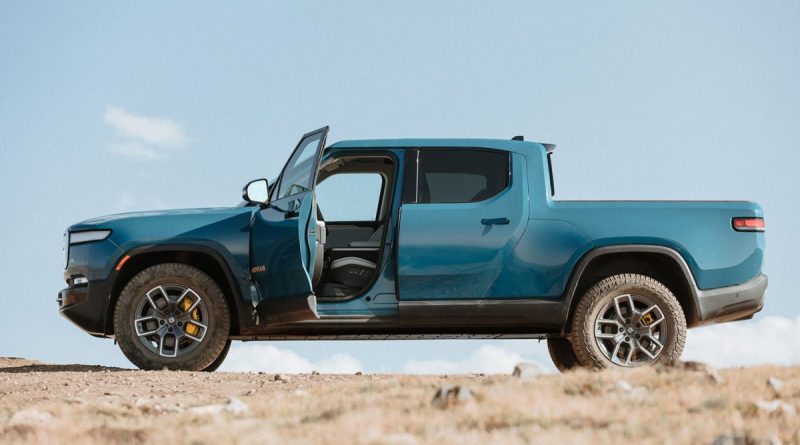 Blue Rivian R1T side view, driver door open