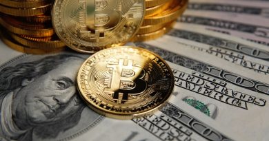 Bitcoin coins cryptocurrency on U.S. dollar banknotes background.
